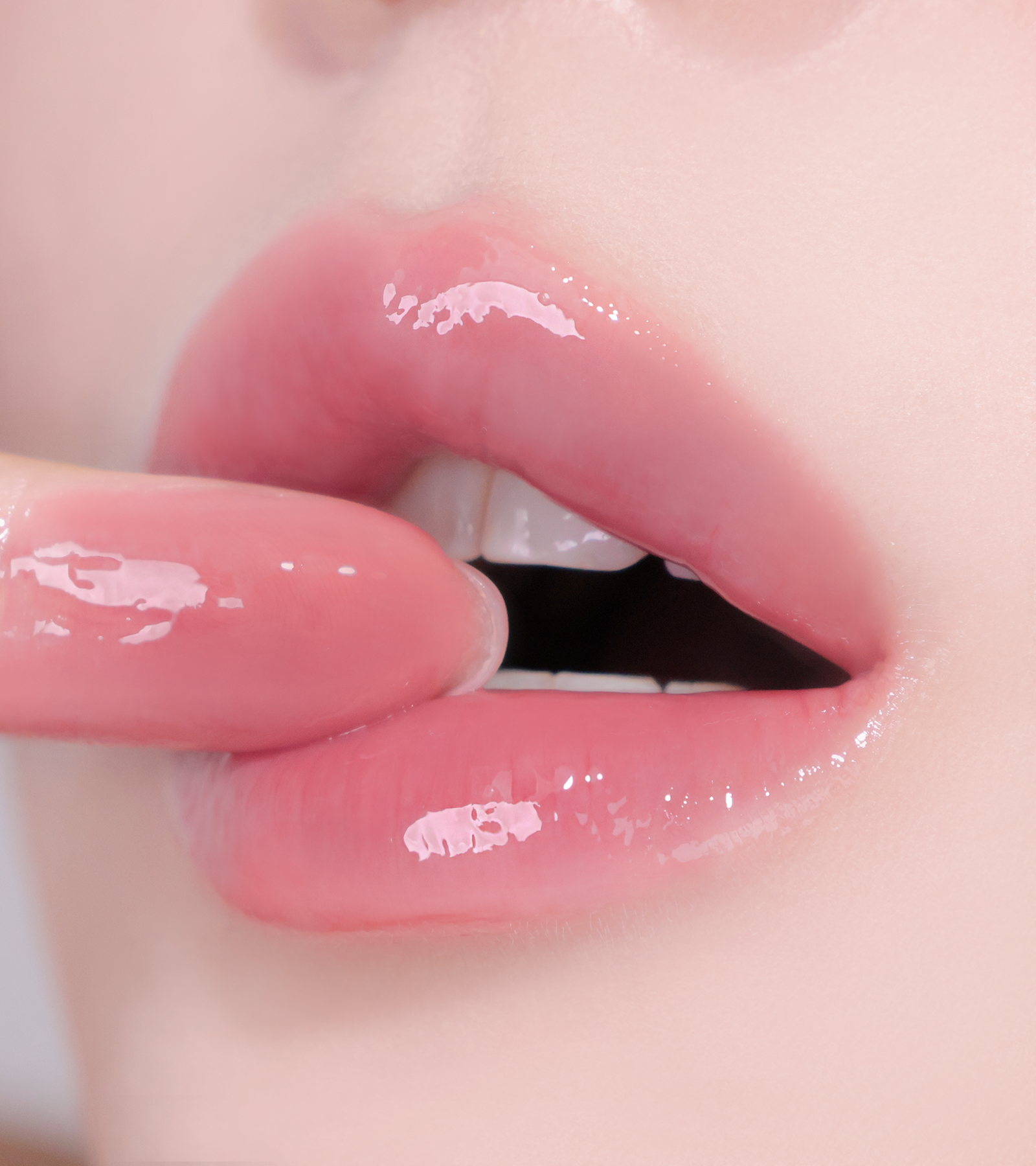 Swatches of HUEMI Melting Glaze Lip Gloss 02 Veiled Mauve on skin